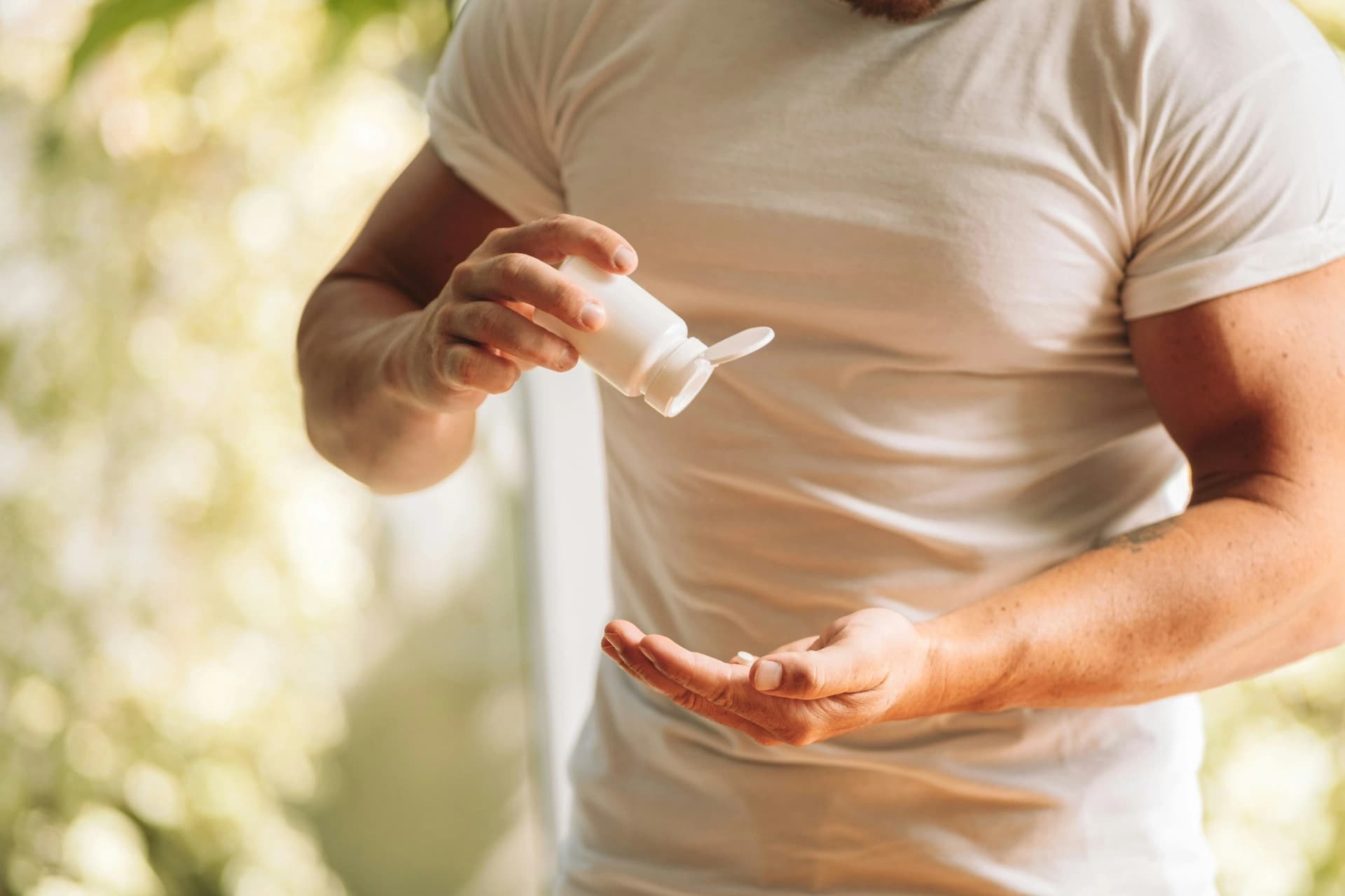 Person using CBD oil drops representing NATURECURE's wellness approach